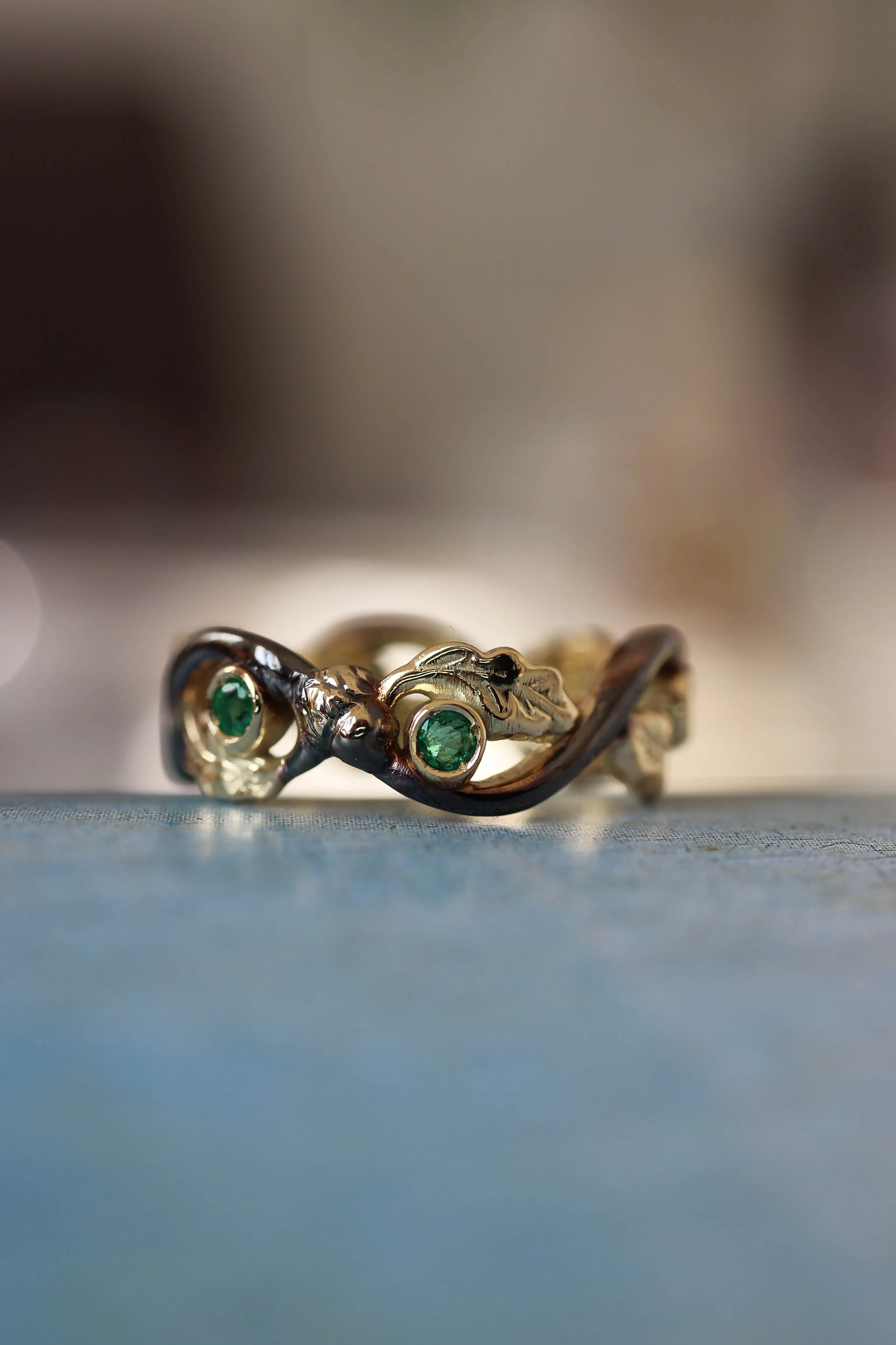 Oak wedding band with natural emeralds