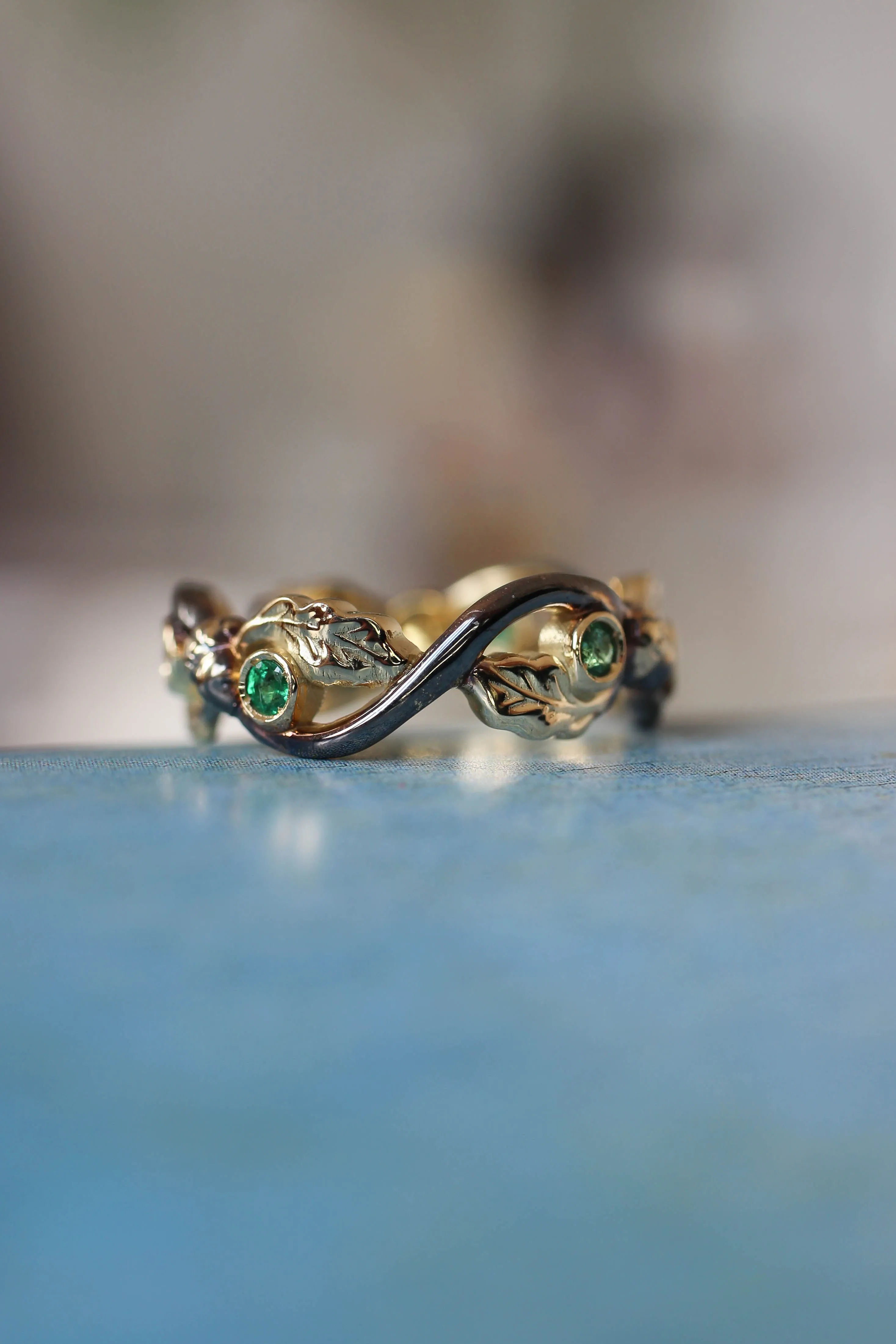 Oak wedding band with natural emeralds