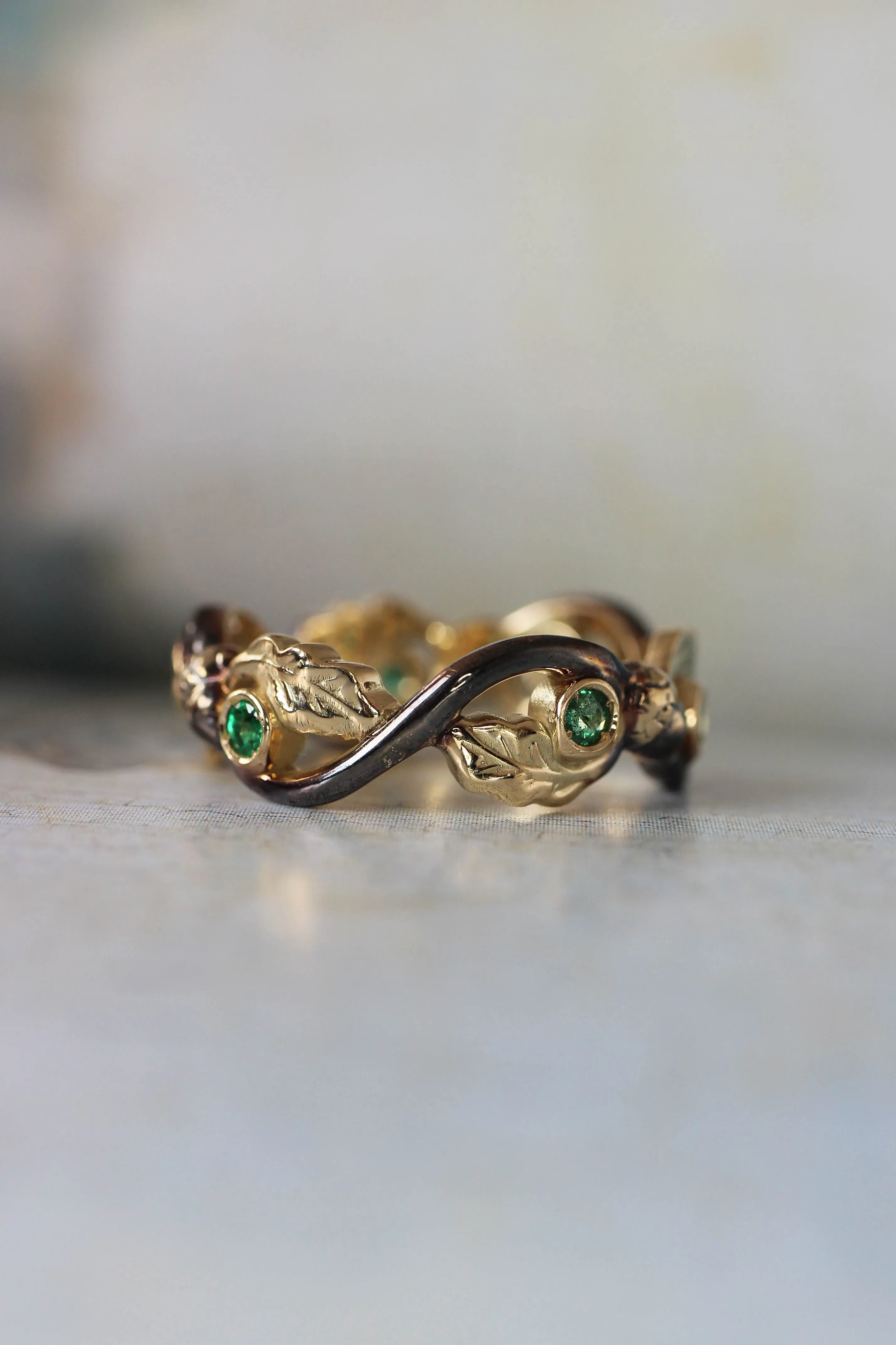 Oak wedding band with natural emeralds