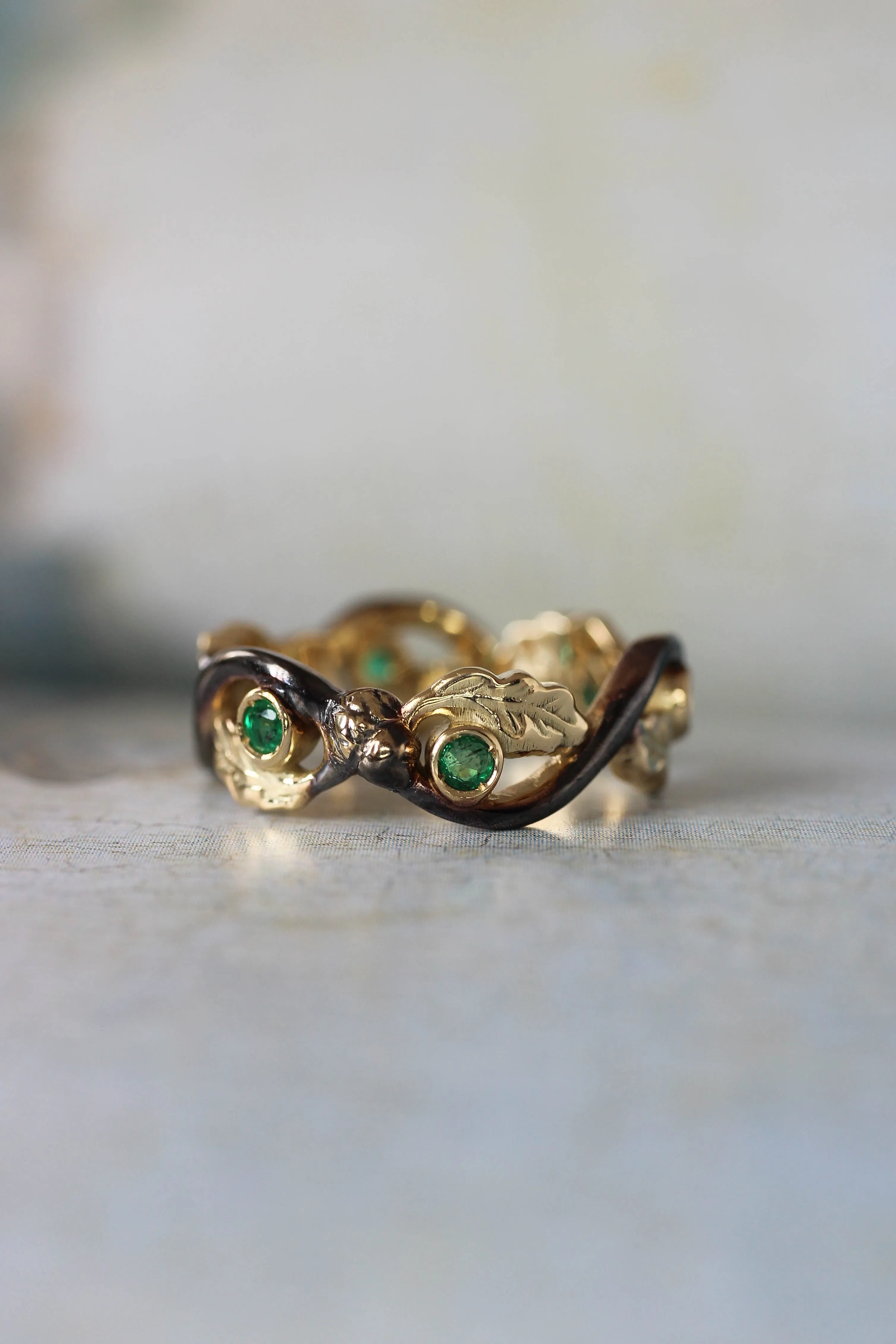 Oak wedding band with natural emeralds