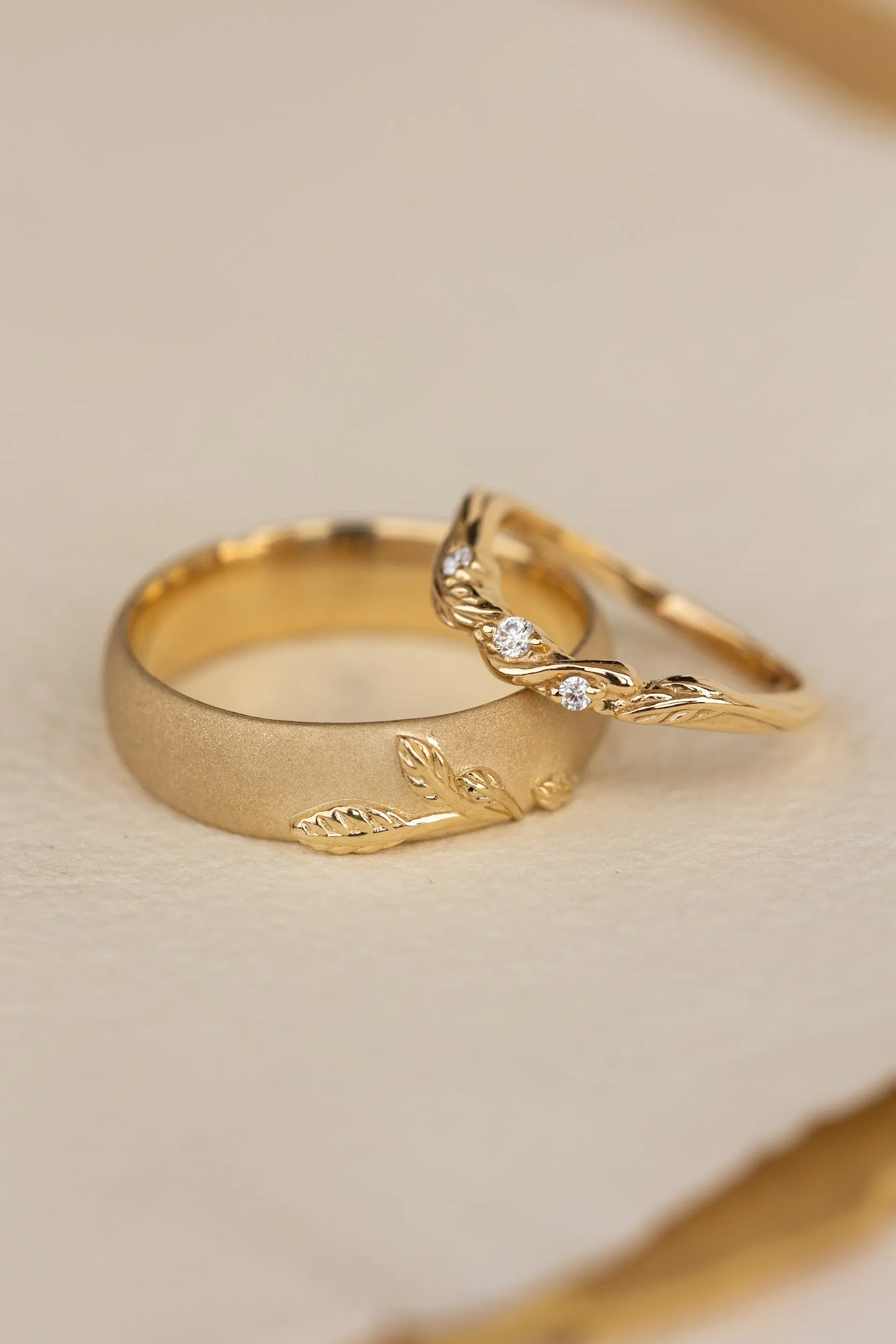 Wedding rings set for couples: satin band with branch for him, curved leaf ring with gemstones for her